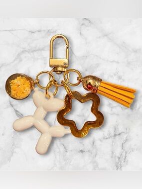 Gold-tone Balloon Dog Keychain with Yellow Tassel